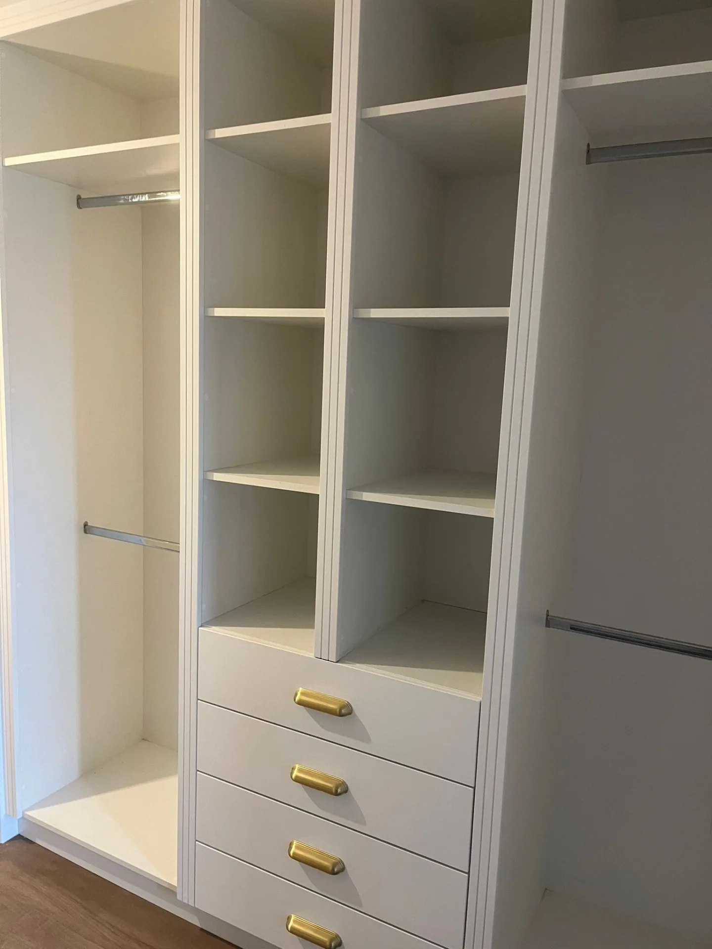 White walk-in wardrobe drawer and shelf detail.